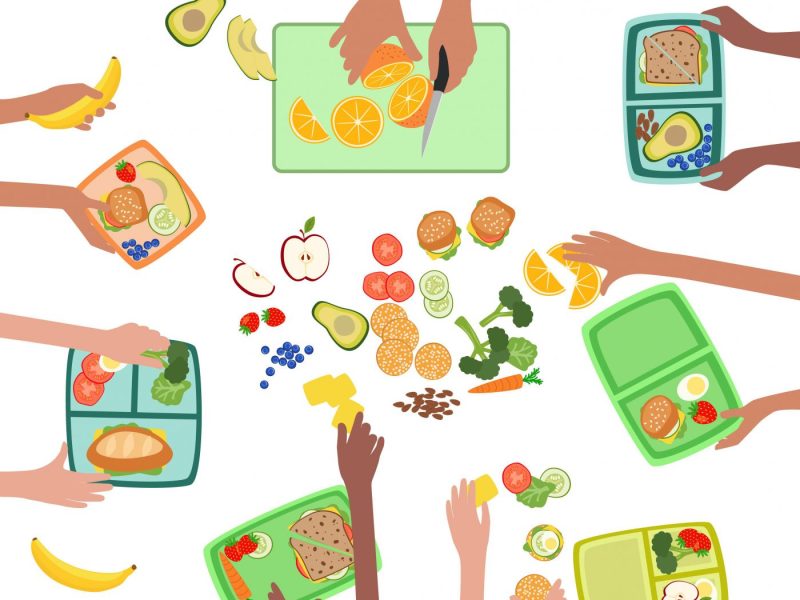 Jausenboxen, die mit Obst und Gemüse gefüllt werden